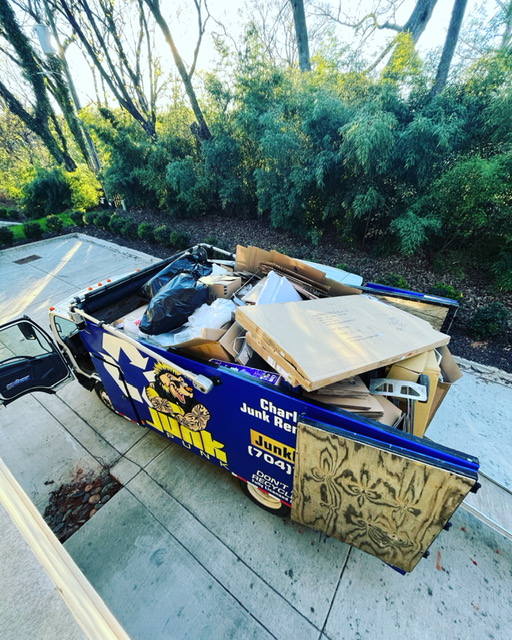 Junk Punk truck filled with debris and furniture for removal service.